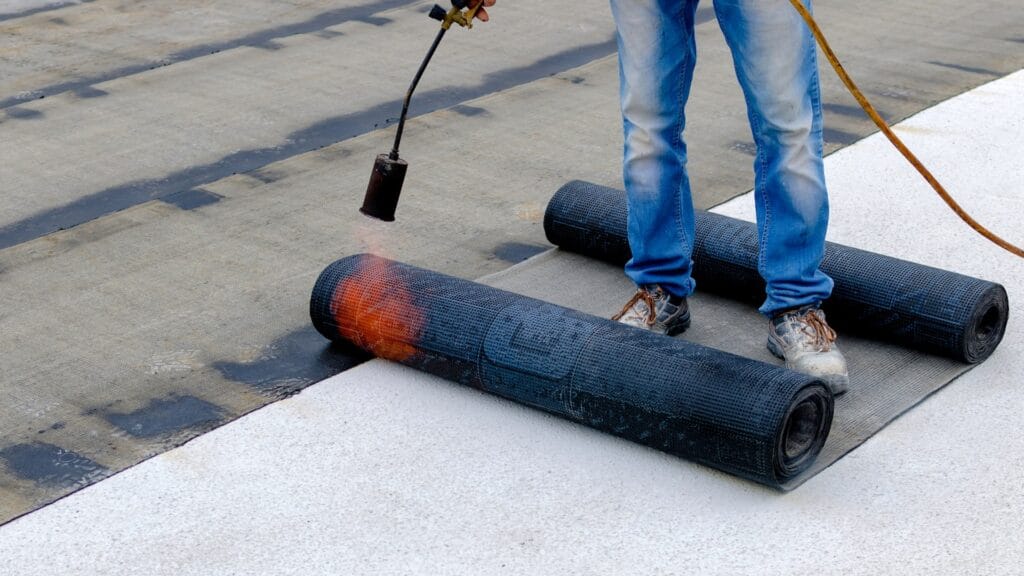 Professional application of waterproofing membrane on a residential deck by Auckland Waterproofing Experts, featuring clean installation and protection against water damage.