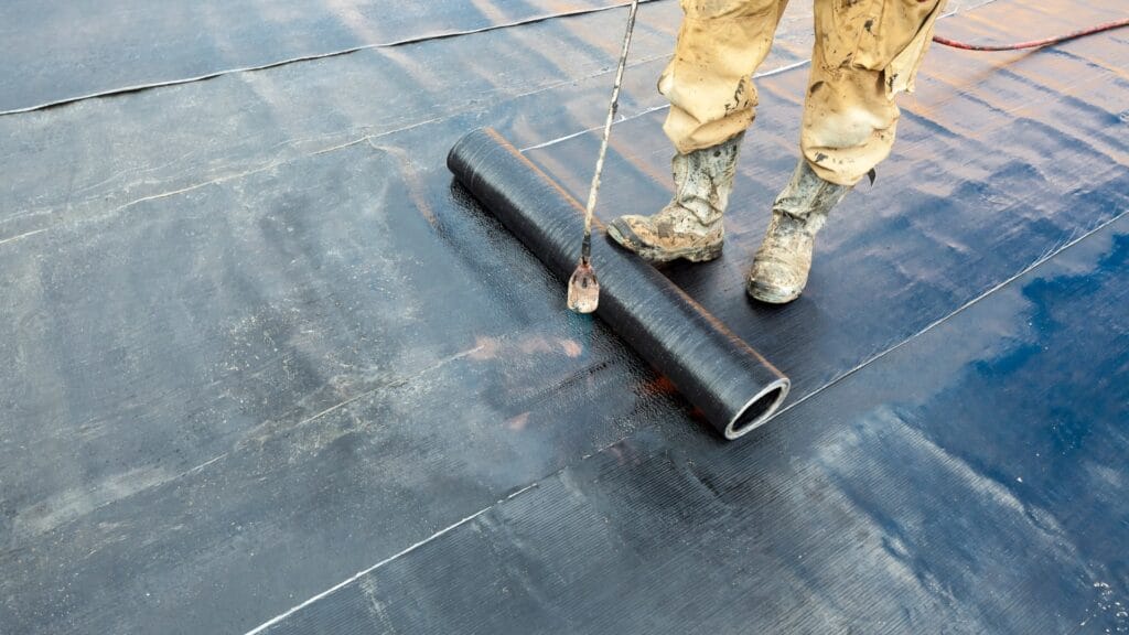 Professional roof waterproofing application in Auckland showing membrane installation by certified waterproofing contractors