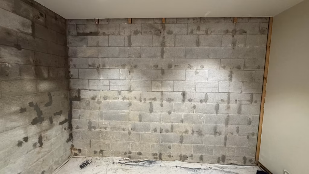 Basement walls in Parnell sealed in light grey ARDEX WPM 300 HydrEpoxy by Auckland Waterproofing Experts after interior waterproofing.